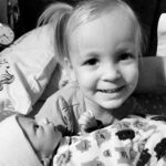 Toddler holding baby