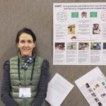 Author in front of a presentation board