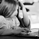 Toddler with parent at computer
