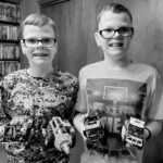 Portrait of boys holding model cars