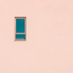 Minimalist photo of small window on plain