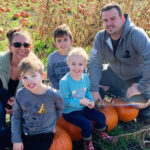 Family portrait in a pumpkin field