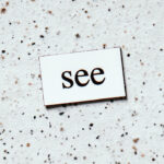 Tile on floor that says See