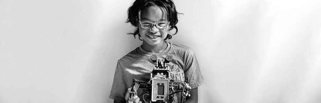 Teen smiling holding device