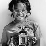 Teen smiling holding device