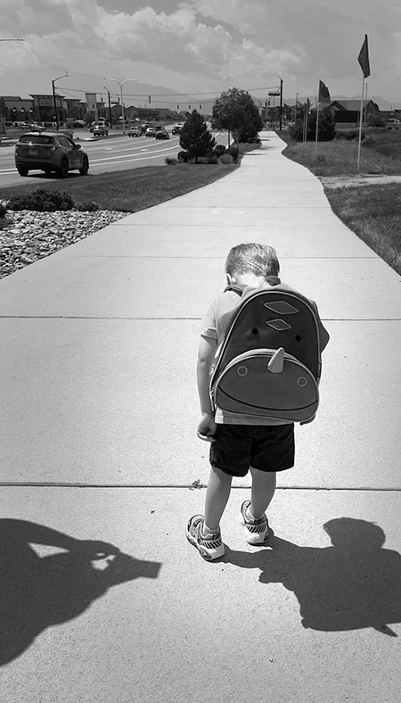 Sad boy on sidewalk