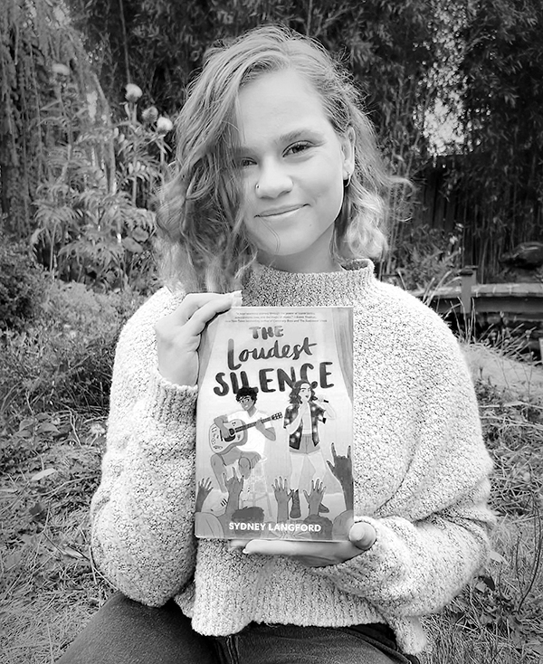 The author holding a book