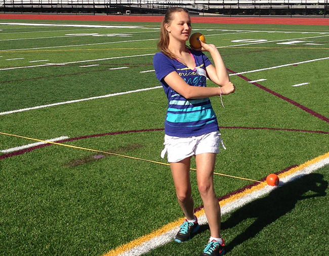 Girl throwing shot put