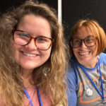 Two ladies smiling for camera