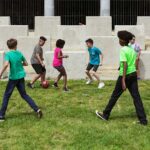 Kids playing soccer at day camp