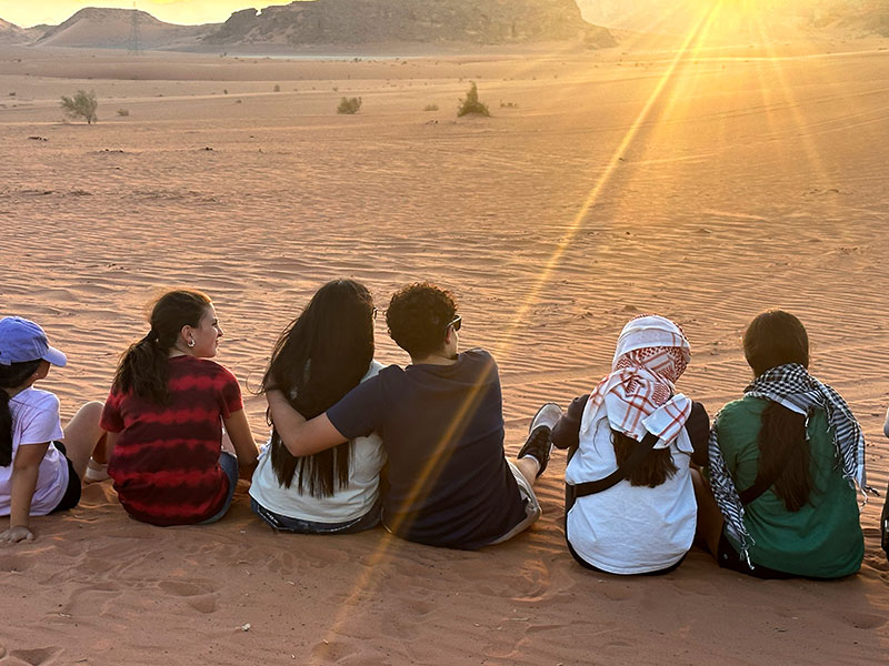 Family sitting looking at the sunset