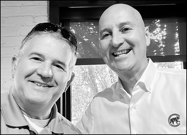 Two men smiling